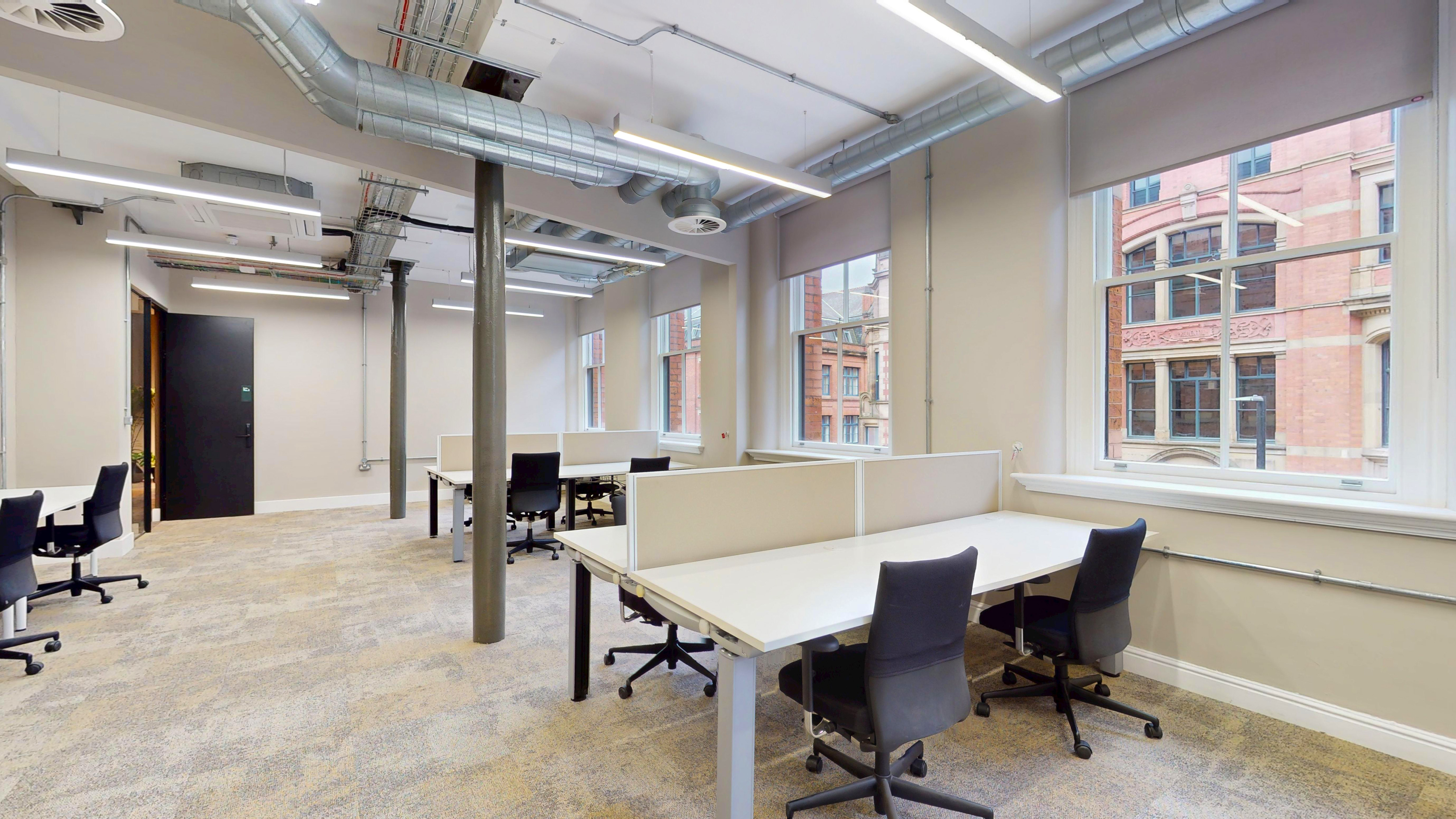 Private suite with desks and heritage windows over central Manchester