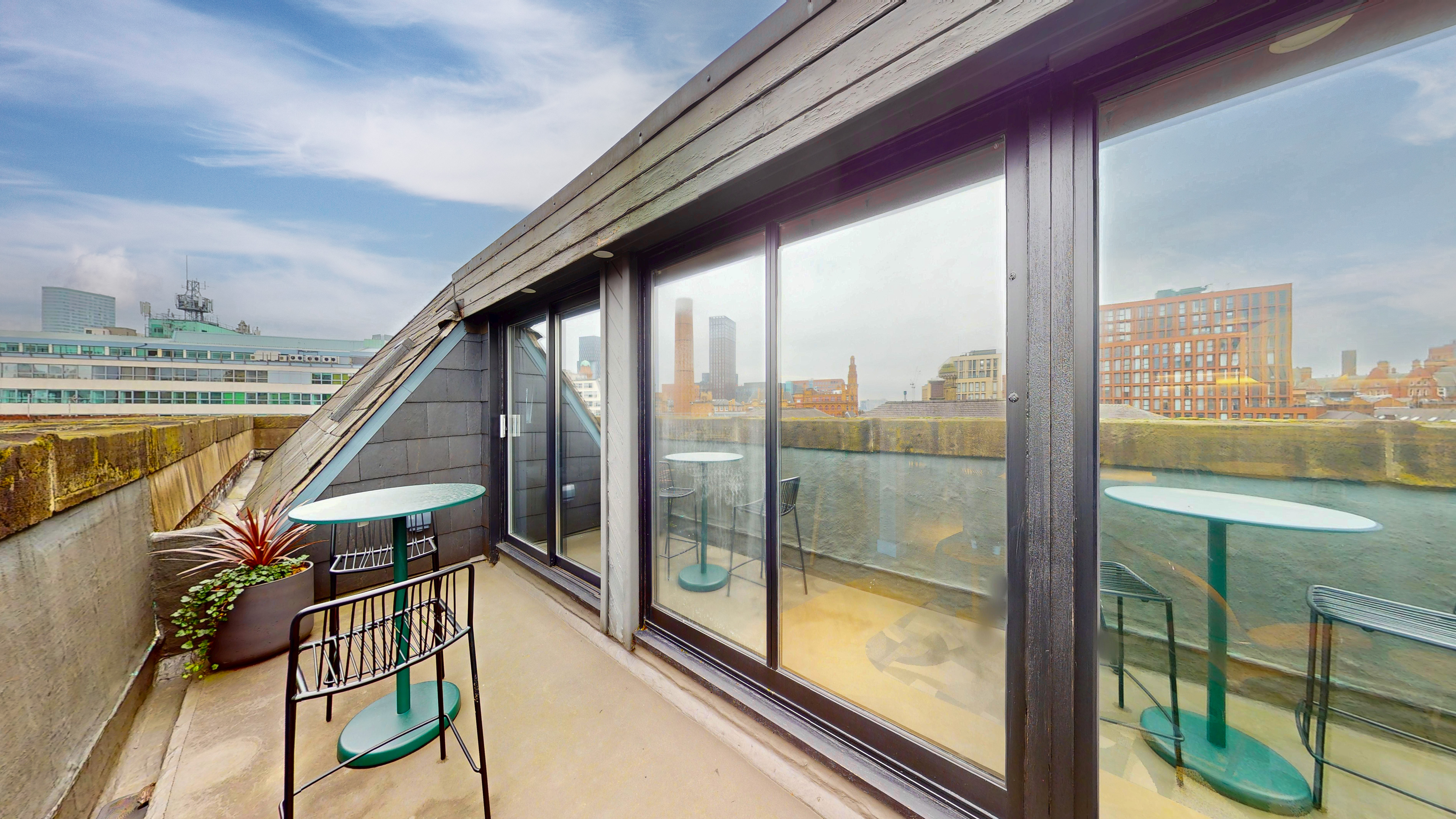 Private rooftop terrace with Manchester skyline and seating